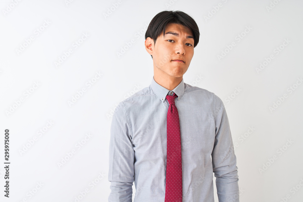 Chinese businessman wearing elegant tie standing over isolated white background looking sleepy and tired, exhausted for fatigue and hangover, lazy eyes in the morning. Chinese businessman wearing elegant tie standing over isolated white background looking sleepy and tired, exhausted for fatigue and hangover, lazy eyes in the morning.