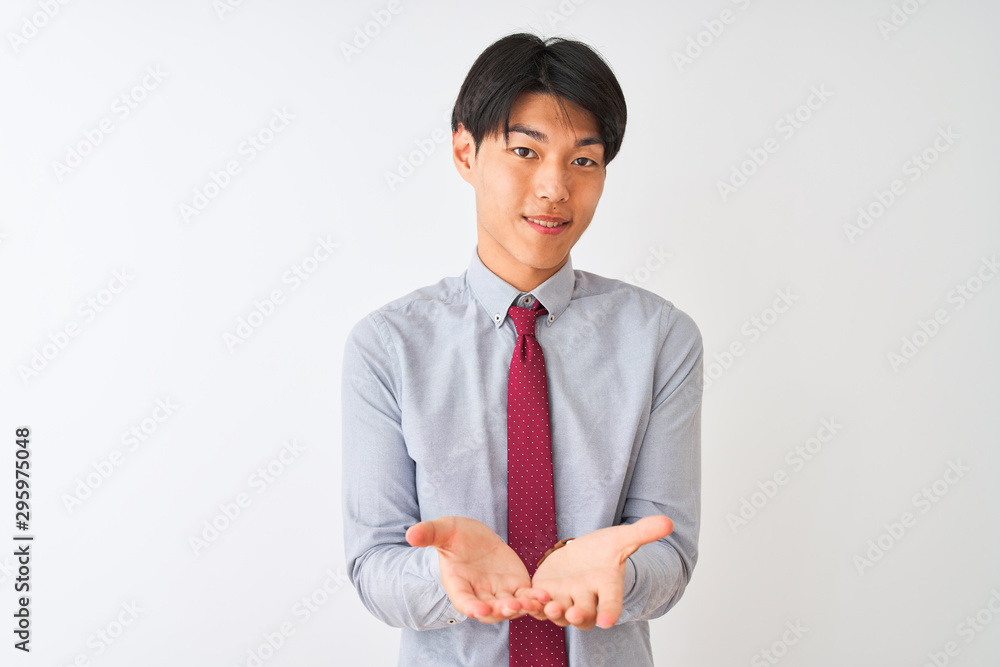 Chinese businessman wearing elegant tie standing over isolated white background Smiling with hands palms together receiving or giving gesture. Hold and protection Chinese businessman wearing elegant tie standing over isolated white background Smiling with hands palms together receiving or giving gesture. Hold and protection