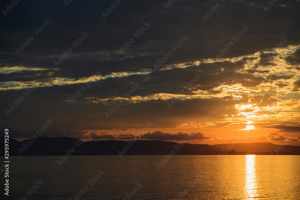 view from sea to sunset over town on sea, horizontal twilight panoramic stock photo image view from sea to sunset over town on sea, horizontal twilight panoramic stock photo image