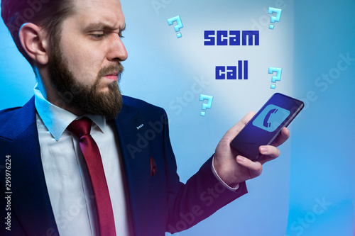 Scam call concept, man looking at cell screen who is calling him