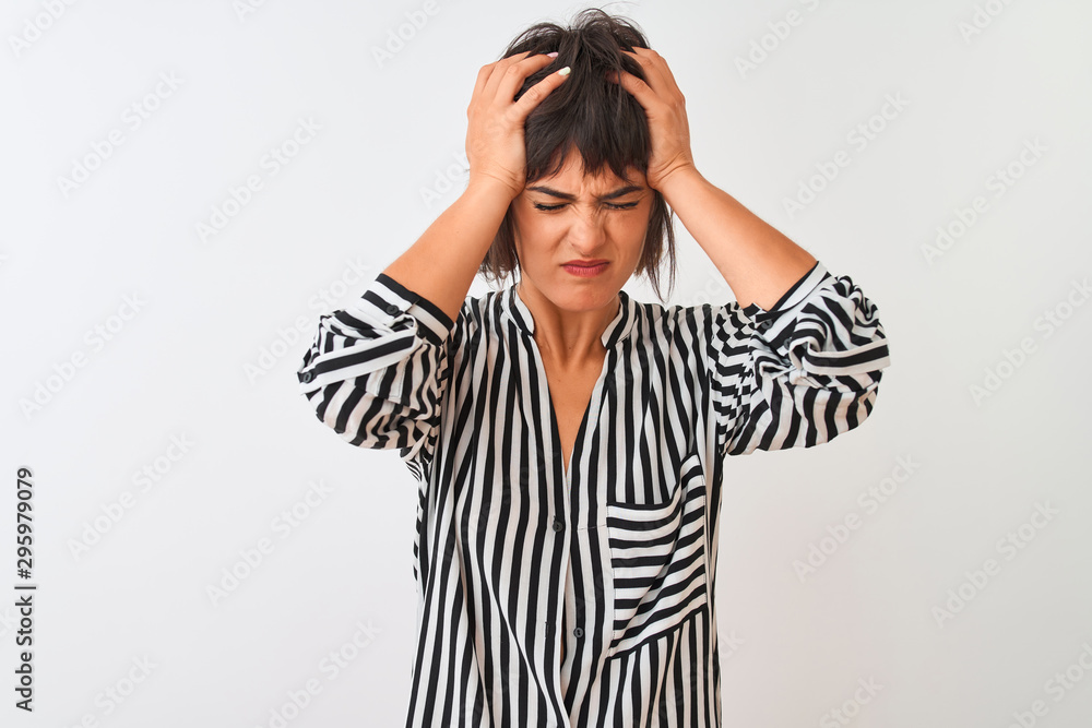 Young beautiful woman wearing striped shirt standing over isolated white background suffering from headache desperate and stressed because pain and migraine. Hands on head. Young beautiful woman wearing striped shirt standing over isolated white background suffering from headache desperate and stressed because pain and migraine. Hands on head.