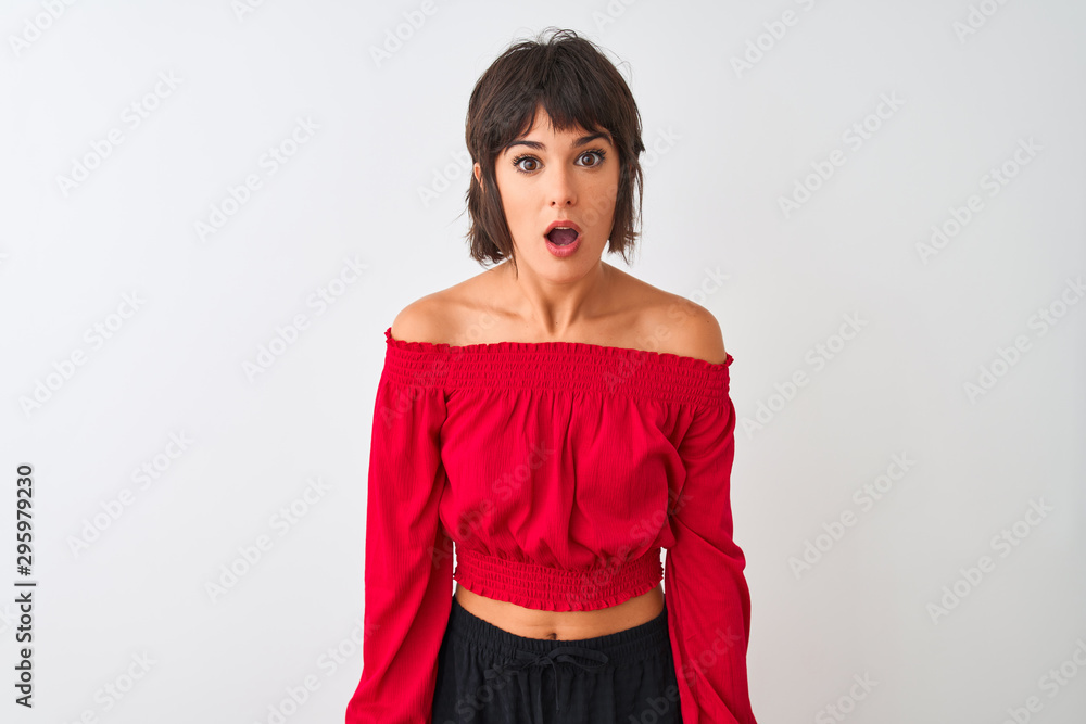 Young beautiful woman wearing red summer t-shirt standing over isolated white background afraid and shocked with surprise and amazed expression, fear and excited face.
