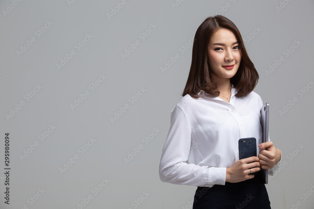 Business woman holding laptop and phone Business woman holding laptop and phone