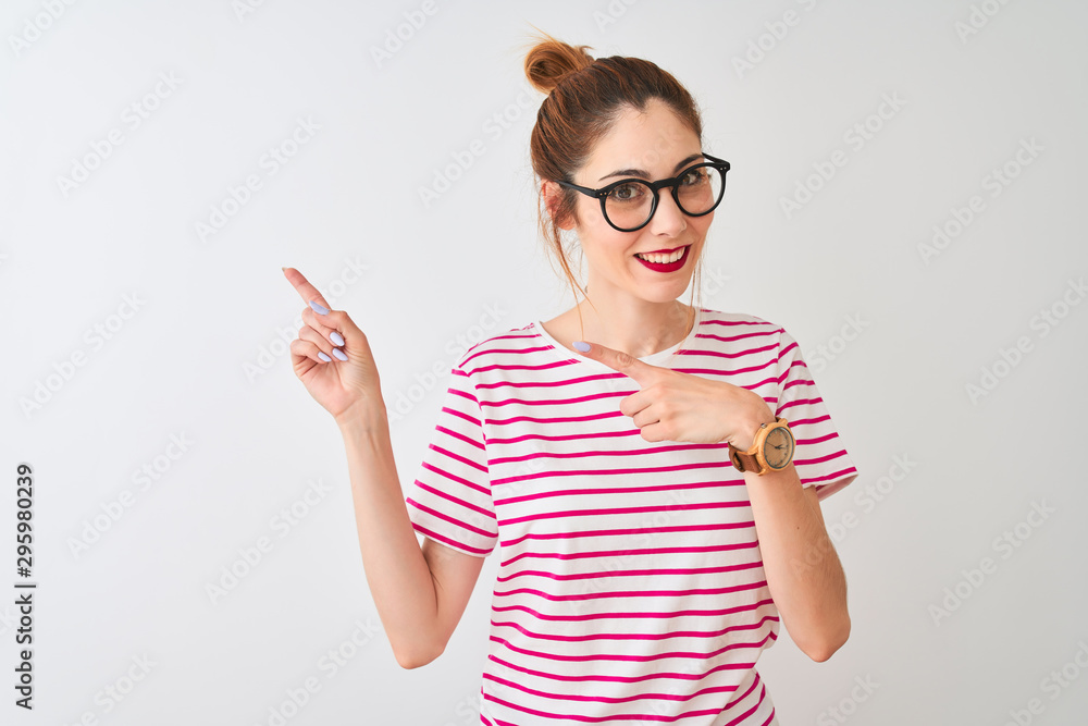 Redhead woman wearing glasses striped t-shirt and pigtail over isolated white background smiling and looking at the camera pointing with two hands and fingers to the side. Redhead woman wearing glasses striped t-shirt and pigtail over isolated white background smiling and looking at the camera pointing with two hands and fingers to the side.