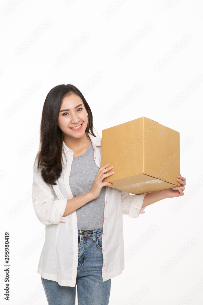Delivery, relocation and unpacking. Smiling young woman holding cardboard box isolated Delivery, relocation and unpacking. Smiling young woman holding cardboard box isolated