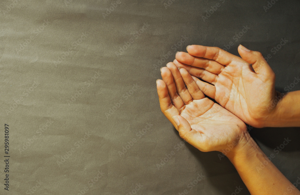 Praying hands top view. Prayer to god with faith and hope young hand on  black background Stock Photo | Adobe Stock