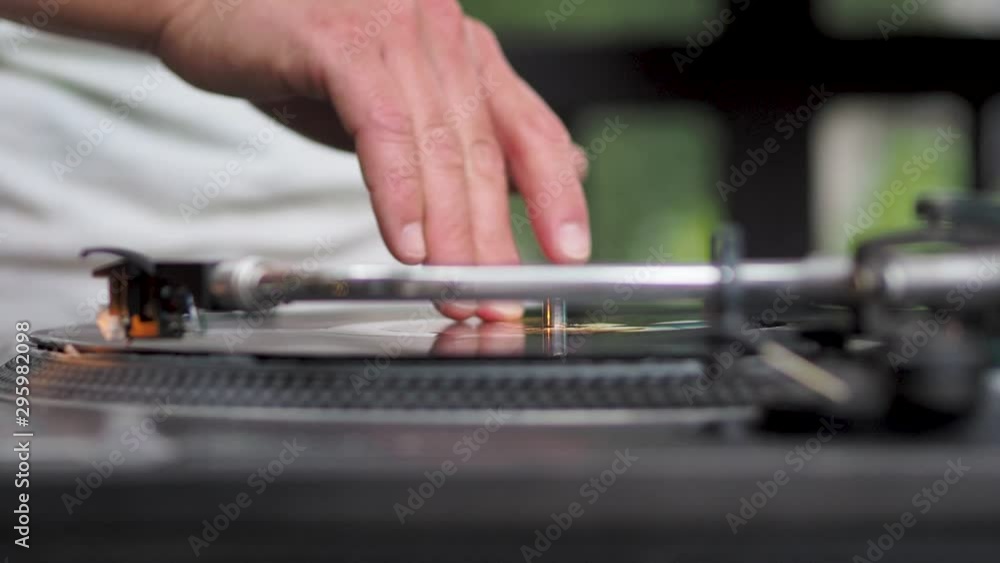 Real DJ at garden party, scratching, mixing and beat-matching. DJ plays a set at a party. Open Air on the summer terrace. Real DJ at garden party, scratching, mixing and beat-matching. DJ plays a set at a party. Open Air on the summer terrace.