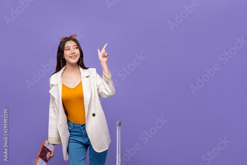 Asian woman tourist pointing hand to copy space