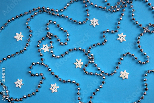 texture of christmas beads and snowflakes on a blue background