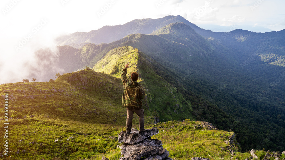 Obraz premium A man standing and looking at the beautiful mountain view
