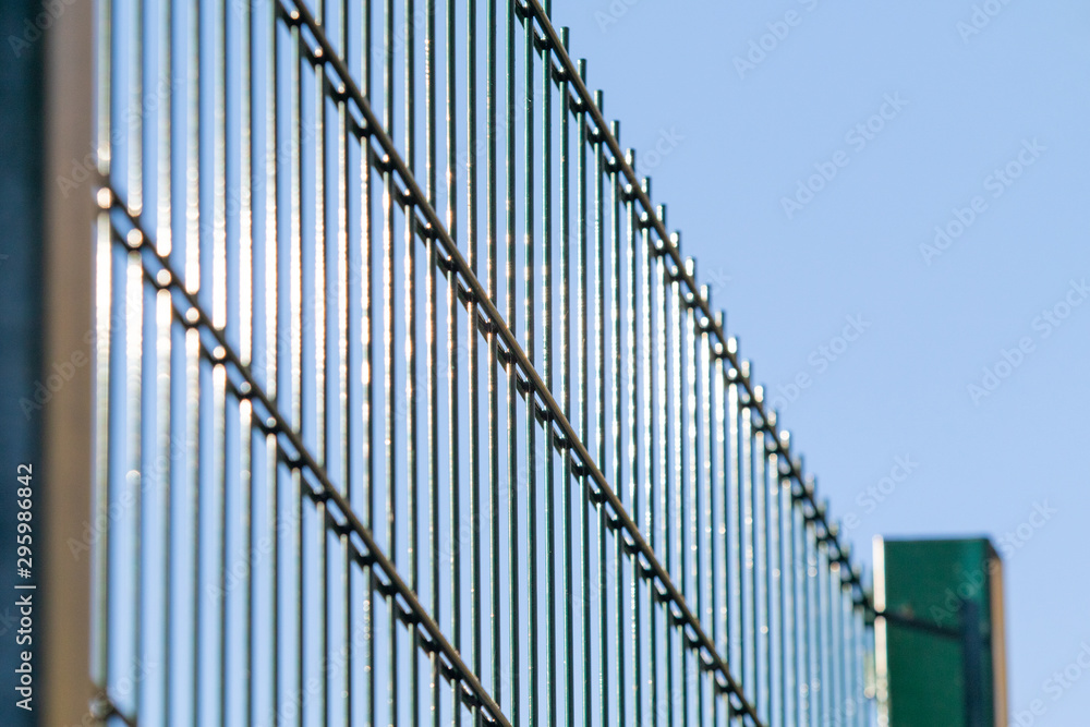 Metal grill against the blue sky. Metal grill against the blue sky.