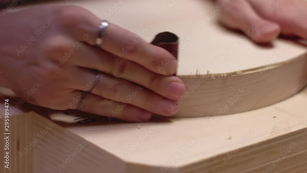 Guitar maker uses sandpaper on acoustic guitar sides Guitar maker uses sandpaper on acoustic guitar sides