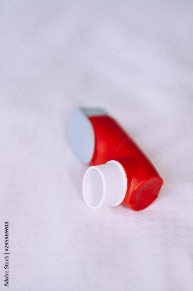 A still life of red and white asthma inhaler devise on a white background  Stock Photo | Adobe Stock