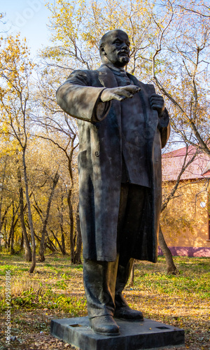 Old abandoned monument to Lenin, a forest in the park.