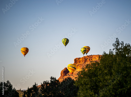 Sedona morning hot air balloon rise over red rock formations