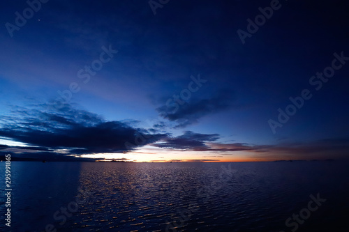 Sunrise in the Salar de Uyuni flooded after the rains  Bolivia. Clouds reflected in the water of the Salar de Uyuni  Bolivia