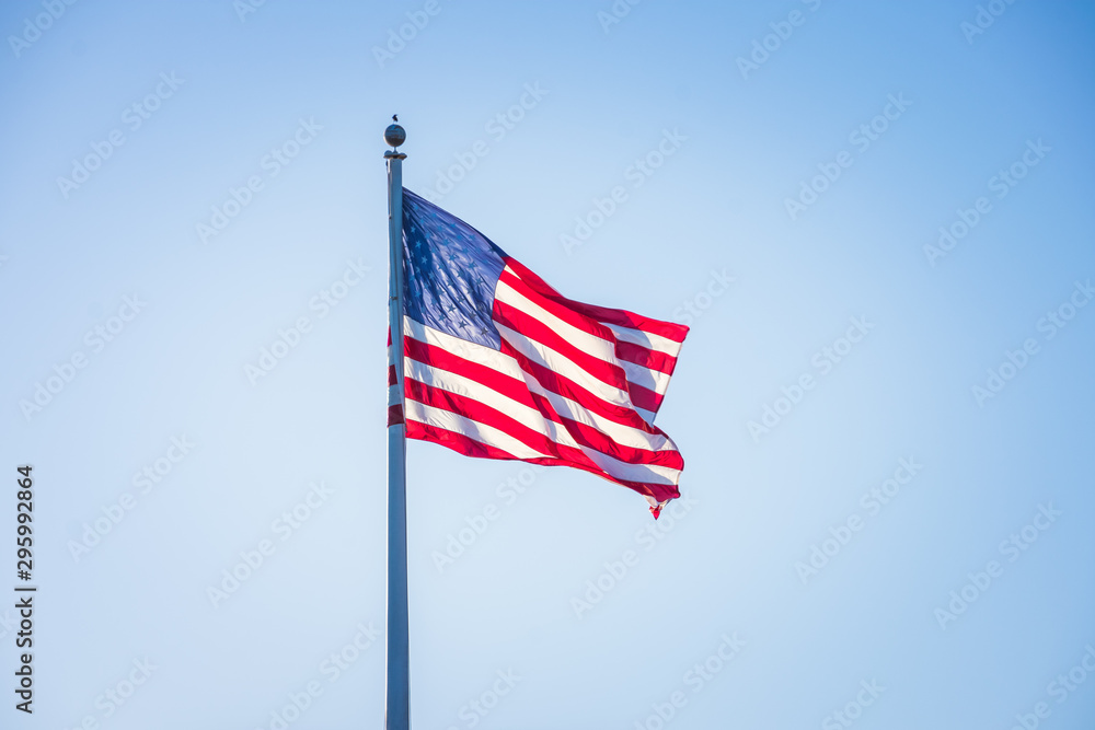 Fototapeta premium American flag on pole flowing in the wind