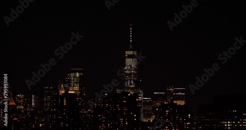 Wallpaper Mural Establishing shot of One World Trade Center in Manhattan, New York City at night with other skyscrapers around it, filmed from Long Island City Torontodigital.ca