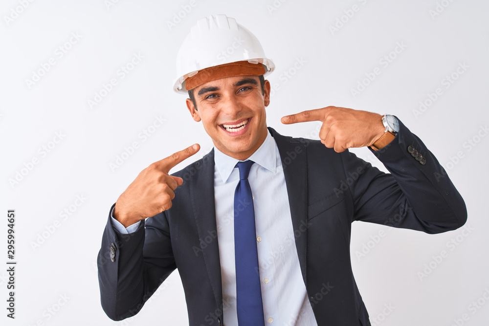 Young handsome architect man wearing suit and helmet over isolated white background smiling cheerful showing and pointing with fingers teeth and mouth. Dental health concept. Young handsome architect man wearing suit and helmet over isolated white background smiling cheerful showing and pointing with fingers teeth and mouth. Dental health concept.