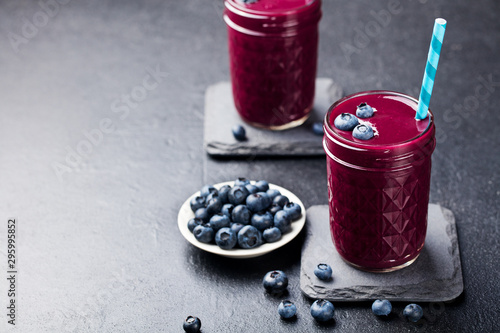 Asai berry smoothie with fresh blueberries. Grey background. Copy space. photo