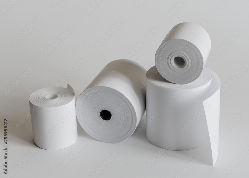 Roll of cash register tape isolated on soft gray background. Photos