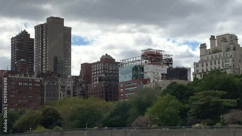 East Harlem buildings at Hudson river waterside. Birds flying by. East Harlem buildings at Hudson river waterside. Birds flying by.