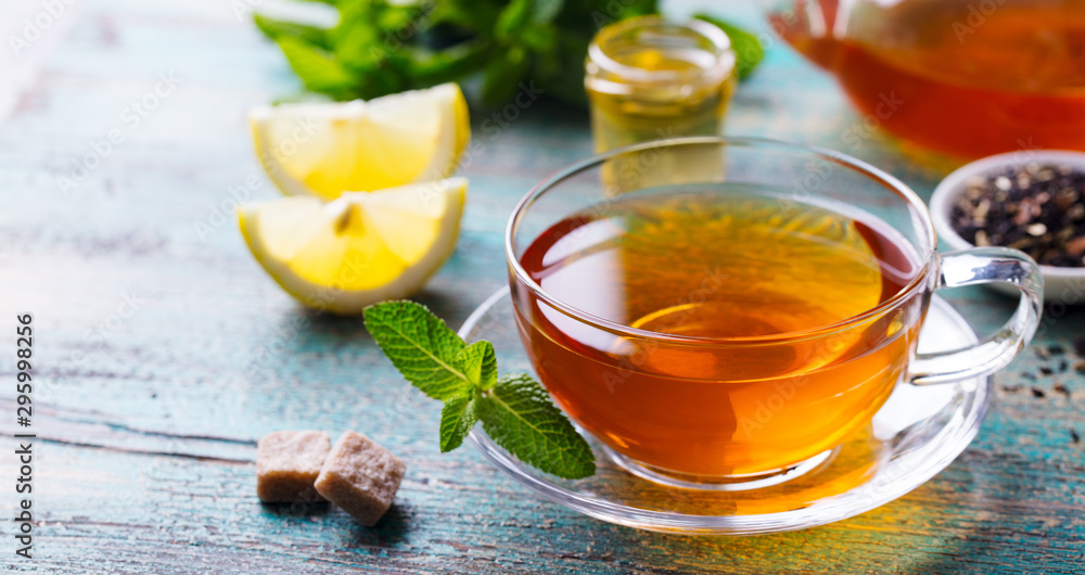 Tea cup with mint leaf. Wooden background. Close up. Copy space. Tea cup with mint leaf. Wooden background. Close up. Copy space.