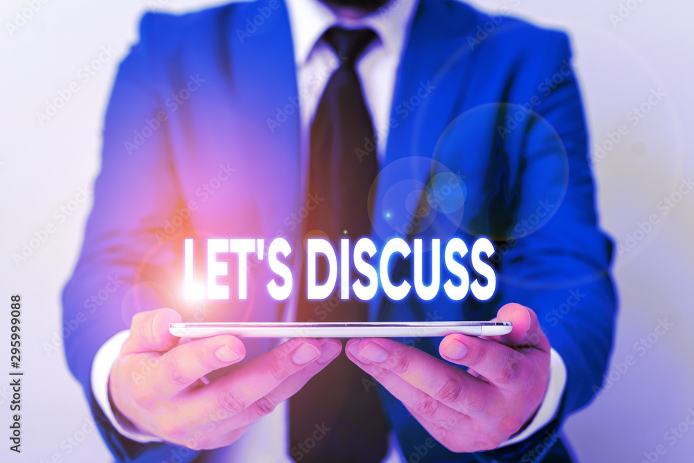 Handwriting text writing Let S Discuss. Conceptual photo asking someone to talk about something with demonstrating or showing Businessman in blue suite with a tie holds lap top in hands Handwriting text writing Let S Discuss. Conceptual photo asking someone to talk about something with demonstrating or showing Businessman in blue suite with a tie holds lap top in hands