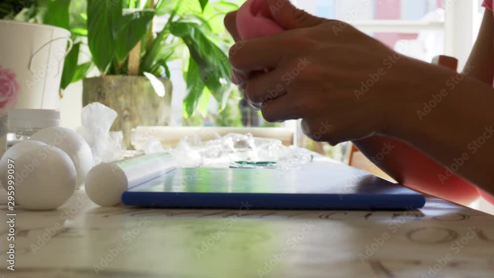 A pastry chef preparing the sugar paste to cover a cake A pastry chef preparing the sugar paste to cover a cake