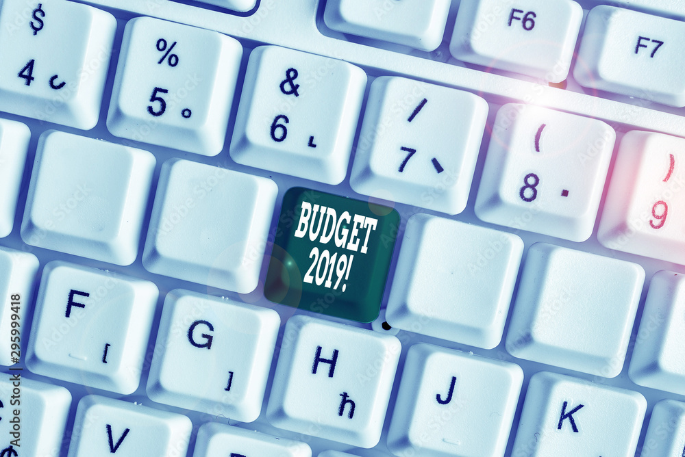 Handwriting text writing Budget 2019. Conceptual photo estimate of income and expenditure for current year White pc keyboard with empty note paper above white background key copy space Handwriting text writing Budget 2019. Conceptual photo estimate of income and expenditure for current year White pc keyboard with empty note paper above white background key copy space