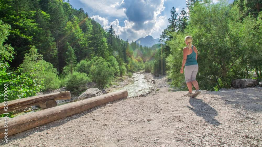 A blonde white woman feeling excited seeing the beautiful view of Pericnik waterfall in Triglav National Park, Slovenia. 4k. A blonde white woman feeling excited seeing the beautiful view of Pericnik waterfall in Triglav National Park, Slovenia. 4k.