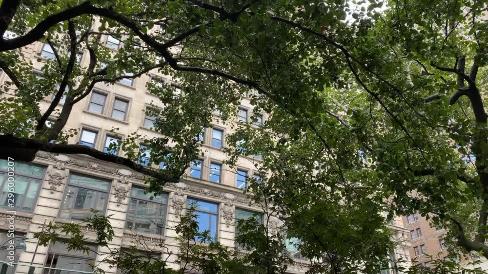New York Manhattan residential building with trees in front. Moving shot. New York Manhattan residential building with trees in front. Moving shot.