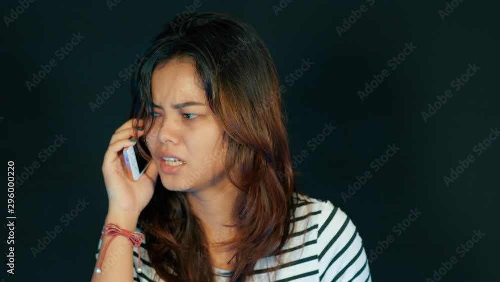 Young woman picks up a phone, immediately gets shocked and bursts in tears. Young woman picks up a phone, immediately gets shocked and bursts in tears.