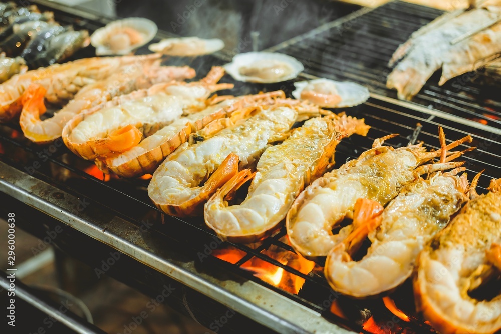 Grilled giant freshwater prawn on the charcoal stove. Street food in famous.
