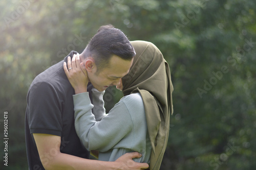 lovely asian Muslim young couple embracing at outdoors