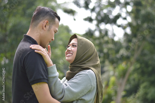 lovely asian Muslim young couple embracing at outdoors © SVRSLYIMAGES