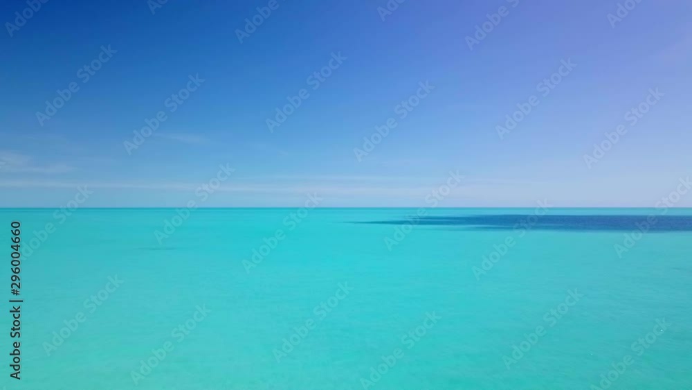 Wide shot of where a horizon is the only separation between different shades of blue Wide shot of where a horizon is the only separation between different shades of blue