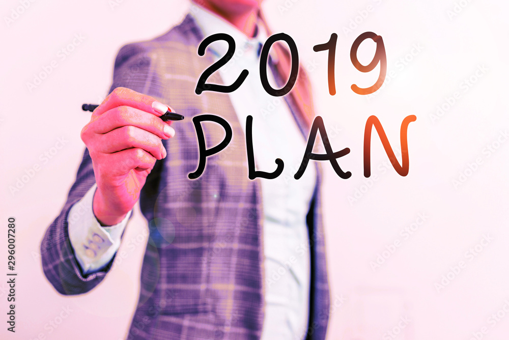 Obraz Writing note showing 2019 Plan. Business concept for setting up your goals and plans for the current year or in 2019 Business woman pointing in empty space with pen