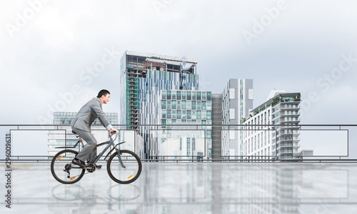 Man riding bicycle on penthouse balcony © adam121