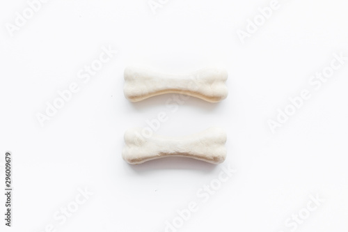 Food and toys for dogs. Chewing bones on white background top view space for text
