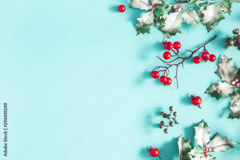 Christmas composition. Frame made of christmas plants on blue background. Flat lay, top view, copy space Christmas composition. Frame made of christmas plants on blue background. Flat lay, top view, copy space