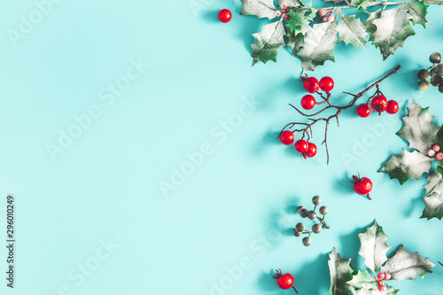 Christmas composition. Frame made of christmas plants on blue background. Flat lay, top view, copy space