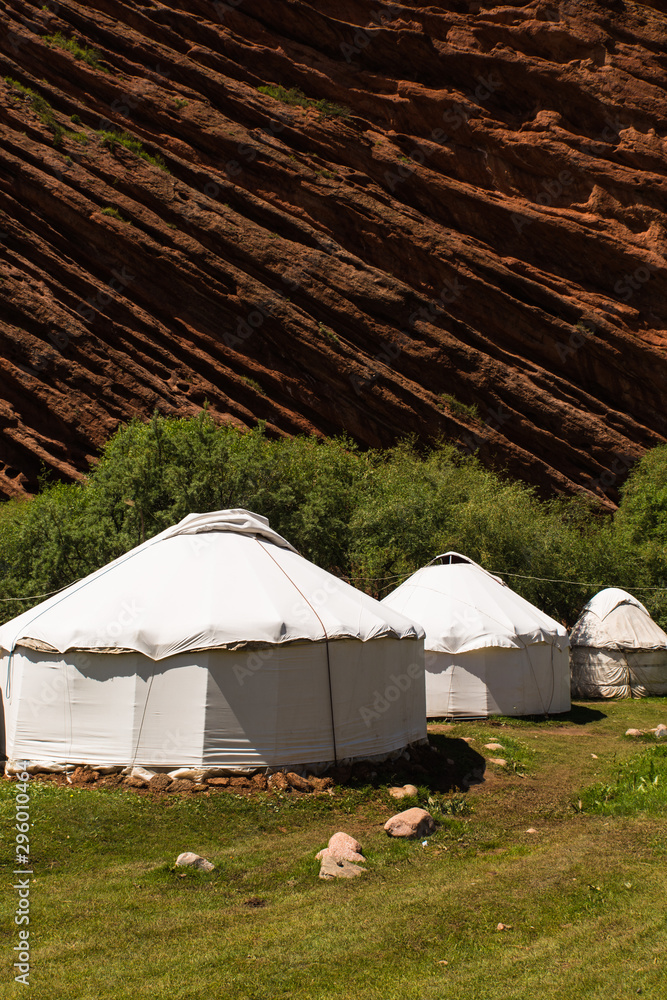 three white yurt houses at seven bulls Jeti Ogyz valley red sandstone formation in Kyrgyzstan