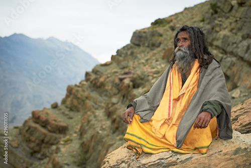 Indian monk sadhu at meditation in mountains