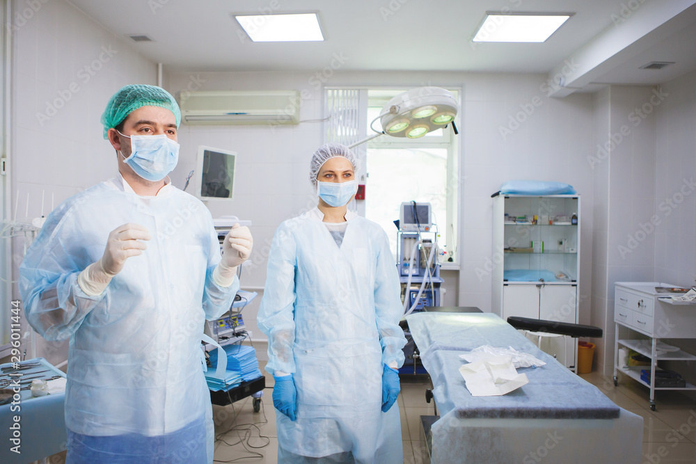 Medical assistant helps a surgeon. Medical assistant helps a surgeon.