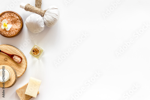 Spa set with massage herbal balls in wellness salon on white background top view frame copy space