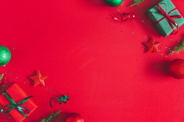 Christmas composition. Gift box, christmas decorations on red background. Flat lay, top view, copy space