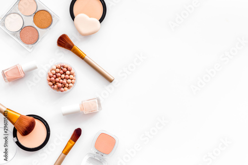 Makeup concept. Frame with decorative cosmetics and brushes on white background top view copy space