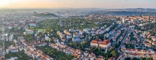 Wide angle aerial panorama of the city in sunrise from hot air balloon