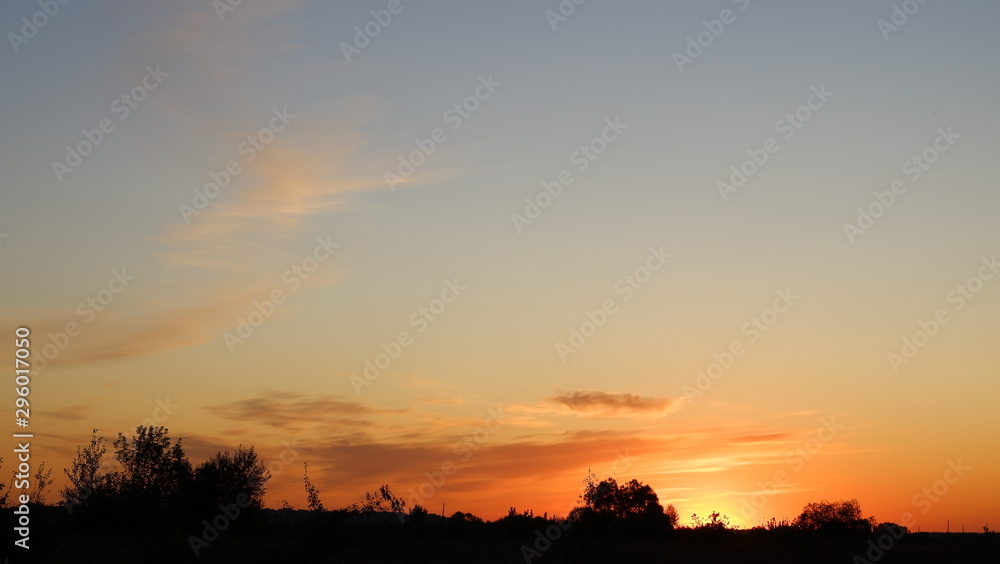 Happy new day concept: summer sunrise over beautiful field and stunning sky Happy new day concept: summer sunrise over beautiful field and stunning sky